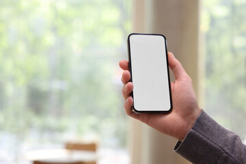 Man using mobile phone on blurred background, closeup. Space for text