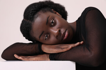 Portrait of young African woman confidently looks at camera has expression. 