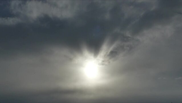 Cloudy sky background with sun and moving clouds - timelapse. Topics: weather, meteorology, clouds texture, sun energy