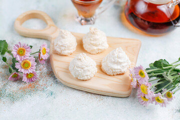 Obraz na płótnie Canvas Delicious homemade meringue cookies with coconut flakes.