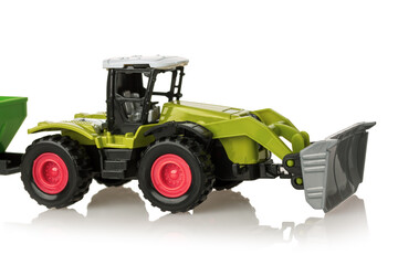 Toy farm tractor with cart, plastic children's play, isolated on white background