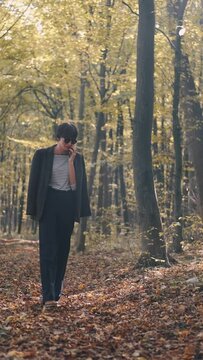 mom with her son in the garden with there dog sitting and playing near the trees