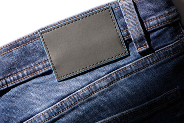 Blank black leather label sewed on a blue denim jeans. Denim jeans with blank label mock up