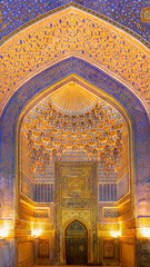 Fototapeta na wymiar Interior of Tilya Kori Madrasah in Samarkand, Uzbekistan. Masterpiece of XVII cent. Mihrab upper part, golden and blue ornaments. Arabic text of Qran (sacred book of muslims) used as part of ornament