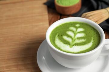 Delicious matcha latte in cup on table, closeup. Space for text
