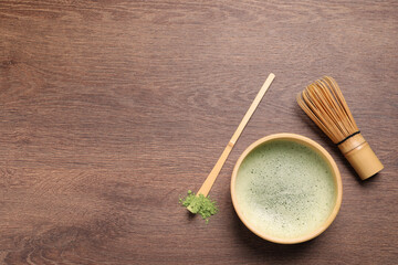 Flat lay composition with matcha tea on wooden table, space for text