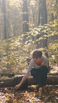 mom with her son in the garden with there dog sitting and playing near the trees