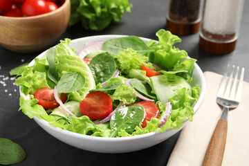 Delicious vegetable salad served on grey table, closeup