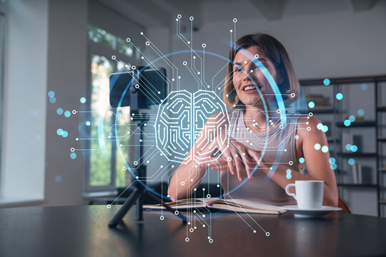 Happy woman is making video blog using smartphone on a tripod explaining with hands at office workplace. Concept of online stream, business education, conference call. Ai technolgy hologram