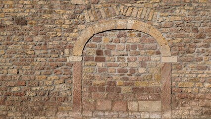 Historic archway bricked up in a wall which could be used to build a new door.