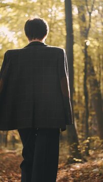 mom with her son in the garden with there dog sitting and playing near the trees