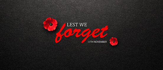 Lest We Forget 11th November inscription with Poppy flower on black textured background. Decorative flower for Remembrance Day. Memorial Day. Veterans day.
