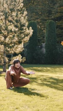 mom with her son in the garden with there dog sitting and playing near the trees