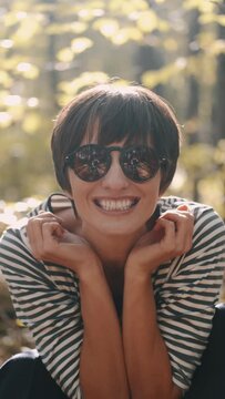 mom with her son in the garden with there dog sitting and playing near the trees