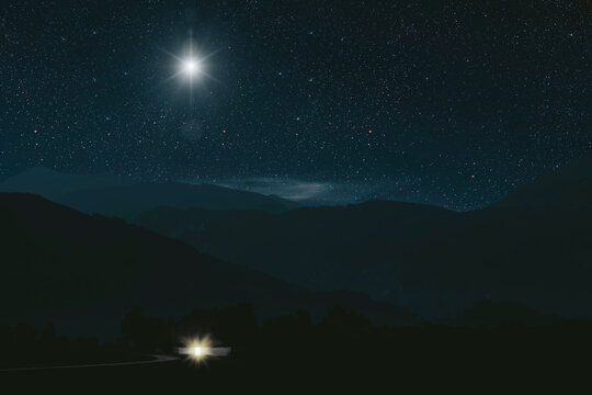 Christmas star shines at night over the mountains of Bethlehem