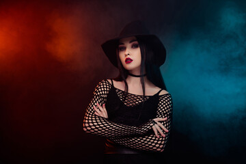 Photo of dark witch on spooky halloween night enchant people over mist effect background