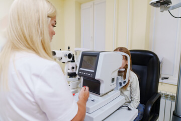teen girl in ophthalmologist's office. computed tomography of the eye