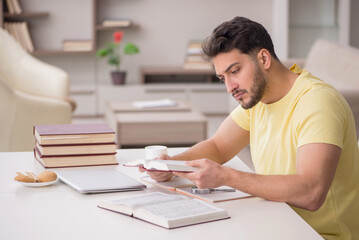 Young male student studying at home