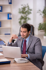 Young male employee working in the office