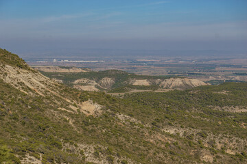 Fototapeta na wymiar View of the Bardena Negra or Bardena black desert landscape of Bardenas Reales with vegetation, Navarra, Spain