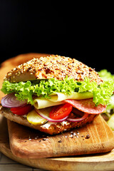 Salami sandwiches with pickles and lettuce.