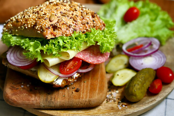 Salami sandwiches with pickles and lettuce.