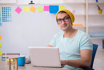 Young male designer sitting in the office