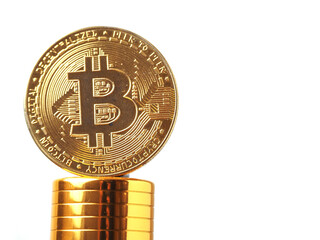 Golden bitcoin on golden basement and white background. Time to invest into crypto currency concept. Economy and financial background. Get rich theme. Alternative money. Selective focus