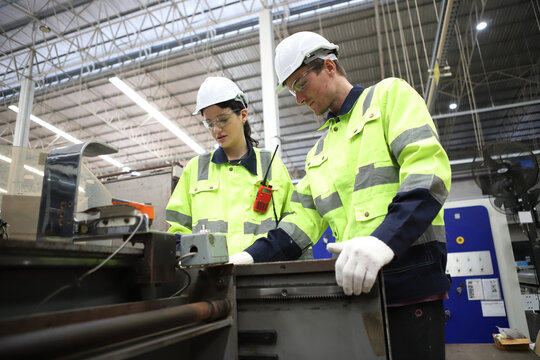 worker or engineer working in factory with safety uniform , safety hat and safety glasses , image is safety concept or happy workplace