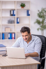 Young male employee working in the office