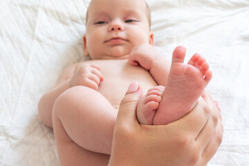 Mother's playtime with baby's tiny feet. Concept of cherished maternal moments