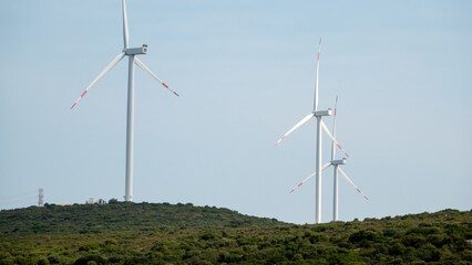 Wind turbines placed on mountains on sunny morning	