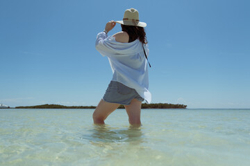unrecognizable woman on vacation on a tropical beach