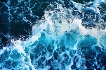 Fototapeta premium Sea wave with foam, top view. Blue ocean wave background. Close up view of ocean water surface. Sea wave texture