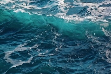 Fototapeta na wymiar Sea wave with foam, top view. Blue ocean wave background. Close up view of ocean water surface. Sea wave texture