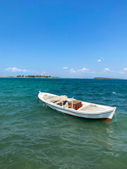 Fototapeta premium Small fishing boat in the cost of Aegean sea in Urla, Izmir, Turkey