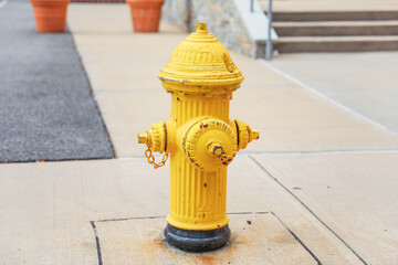 fire hydrant stands on a city sidewalk, symbolizing safety, preparedness, and emergency response,...