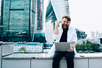 Excited entrepreneur enjoying triumph in business district