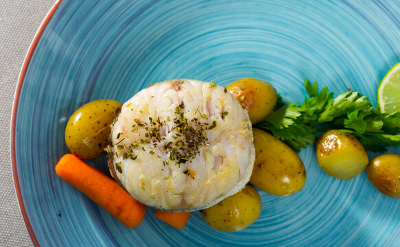 Steak of cod by rustically frying and served with boiled potatoes, carrots and greens