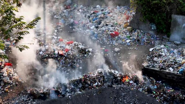 Trash and fire. burning of waste in the waste disposal area. Burning waste in urban areas causes toxins in the air, air pollution, environmental damage and global warming