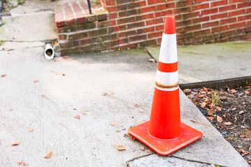 construction cone on urban road, representing safety, work in progress, and traffic control in a...