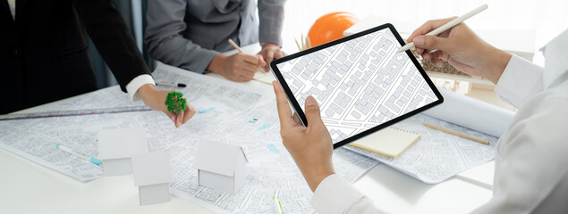 Worker, architect and engineer work on real estate construction project oratory planning with...