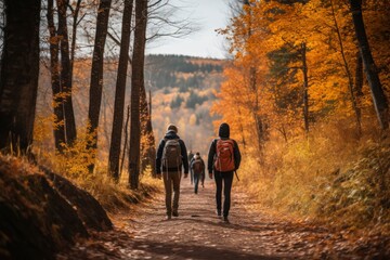 Fototapeta premium A picturesque view of friends and family taking a scenic hike through a colorful autumn forest on Thanksgiving Day, experiencing the beauty and serenity of the great outdoors