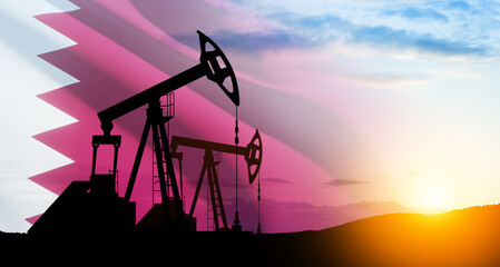 Oil drilling derricks at desert oilfield with Qatar flag. The change in oil prices caused by the...