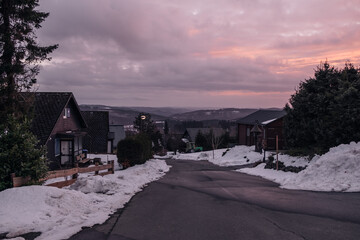 sunset over small town in winter