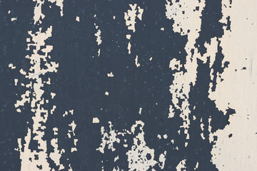 Peeling paint on the wall. Old concrete wall with cracked flaking paint. Weathered rough painted surface with patterns of cracks and peeling. High resolution texture for background and design. Closeup