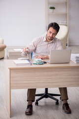 Young male accountant working in the office