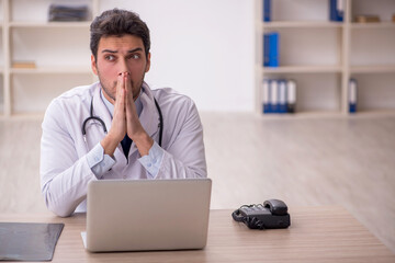 Young male doctor working in the clinic