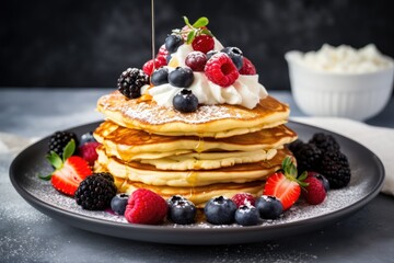 Partial keto pancake stack with coconut or almond flour topped with berries whipped cream and one slice devoured