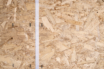 Closeup of a section of new Oriented Strand Board (OSB) engineered wood used in home construction
